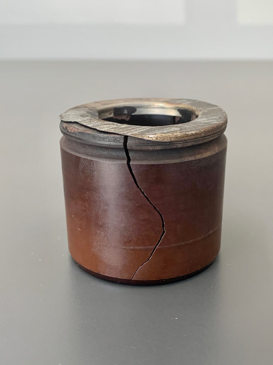 Photo of a cracked phenolic caliper piston