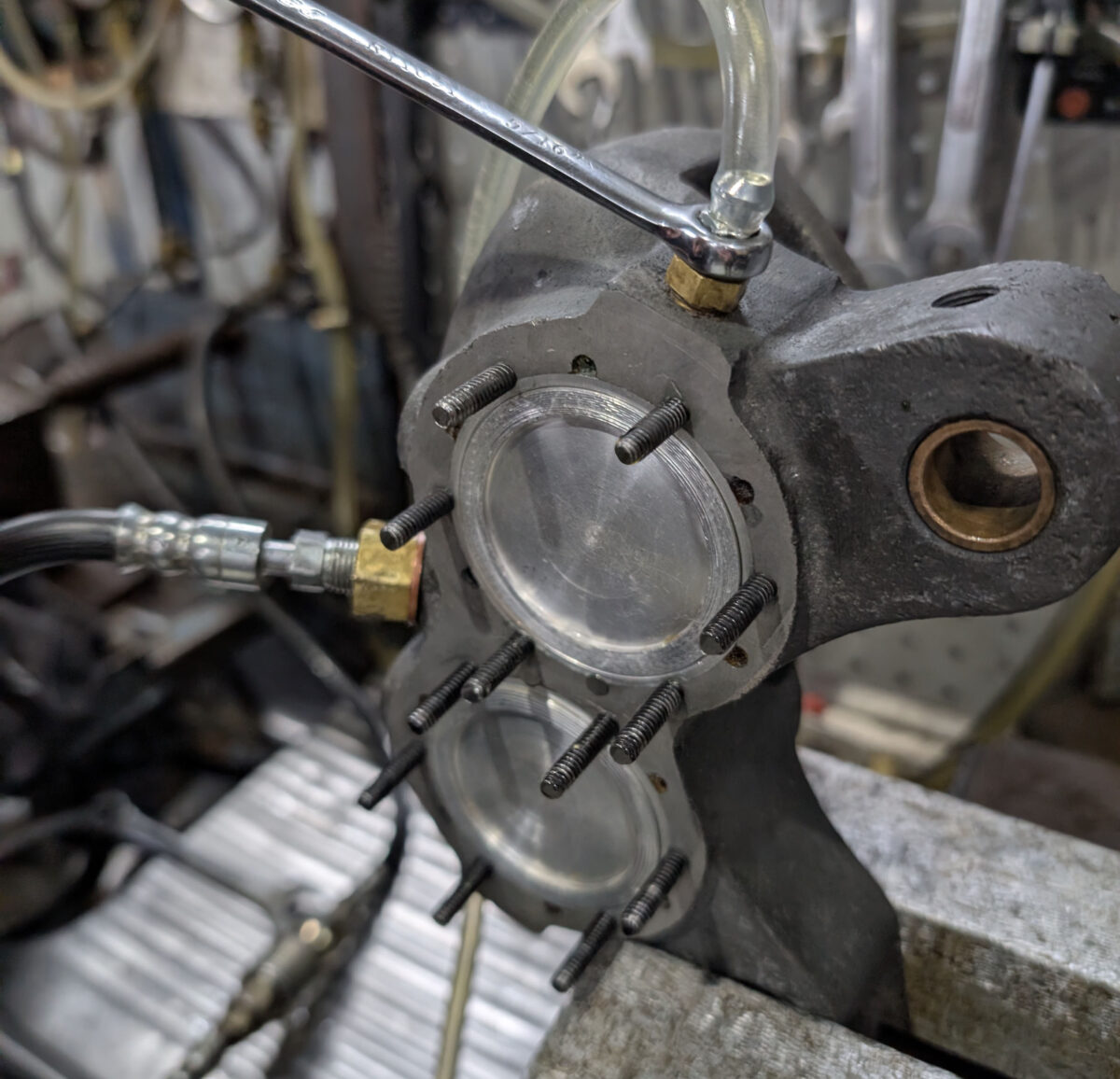 Photo of a Halibrand caliper on a test bench being fluid tested.