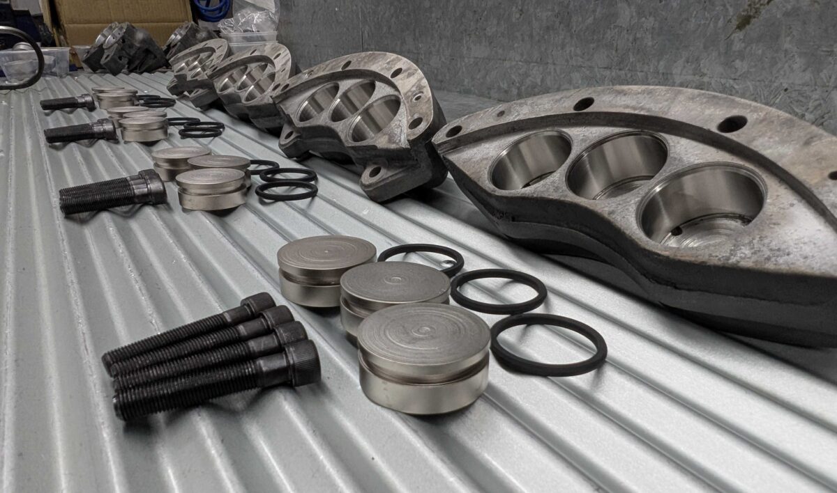 Photo of new parts laid out on the bench to assemble EDCO calipers